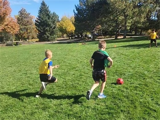 Two children playing soccer