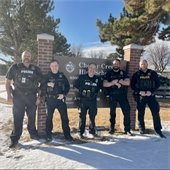 GVPD School Resource Officers pose in front of the CCHS sign.