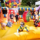 Kids playing in a bounce house.