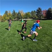 Children running in a field playing sports.