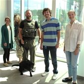 Officer Beachem and K-9 pose with CoBank employees at Ready for Duty celebration.