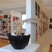 Youth Art Month exhibit featuring sculpture and colorful wall art.