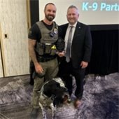 Officer Speer and K-9 Mercury accept their award.